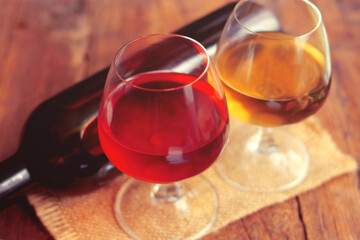 Glass of wine, bottle, grapes on a background of boards.