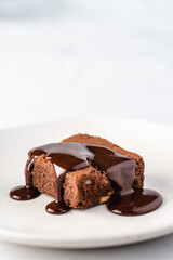 chocolate cake on a plate with chocolate sauce