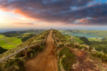
a man takes a photo from the top of the Grota do Inferno viewpoint. Sete cidades. Sao Miguel. Azores. Portugal