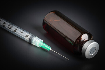 Disposable Injection And Amber Color Vial On Black Background