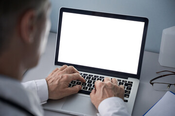 Male doctor using laptop computer with blank white mockup screen technology for tele medicine medical healthcare tech website ad concept, video call e telehealth online appointment. Over shoulder view - Powered by Adobe
