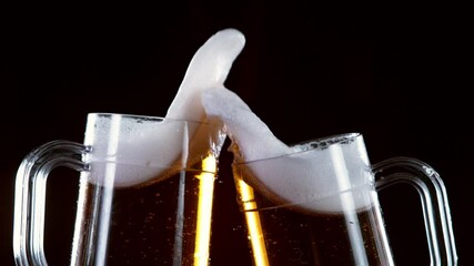 Super slow motion of beer glasses in cheers gesture. Filmed on high speed cinema camera, 1000 fps.