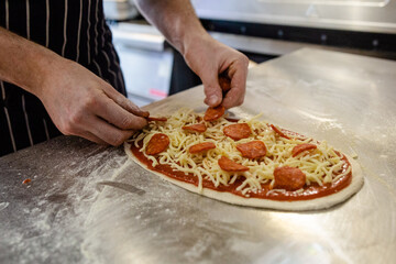Fresh flatbread pizza topped with pepperoni cheese and tomato sauce