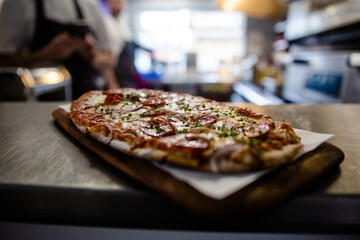 Fresh flatbread pizza topped with pepperoni cheese and tomato sauce