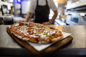 Fresh flatbread pizza topped with pepperoni cheese and tomato sauce