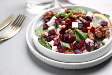 Delicious beet salad served on grey table, closeup
