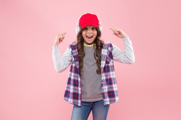 happy teen girl in cap and headphones. kid casual fashion style. cheerful child listen music.