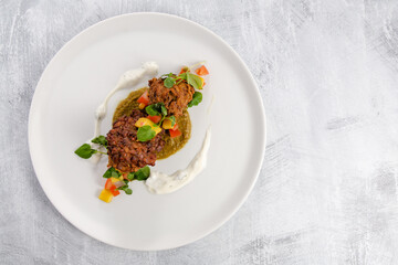 Onion bhaji with chili sauce on a white plate