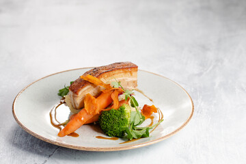 Roasted pork belly with potatoes and seasonal vegetables