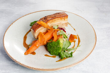 Roasted pork belly with potatoes and seasonal vegetables