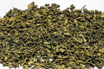 Gunpowder Green Tea Scattered. Large tea leaves close up.