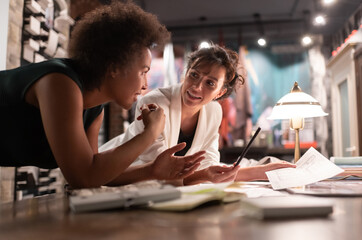 Cheerful diverse women discussing architectural project