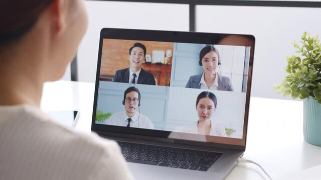 Young Asian businesswoman work at home and virtual video conference meeting with colleagues business people, online working, video call at home office