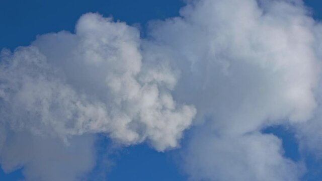 beautiful fluffy fast moving white clouds smoke blue sky in real time