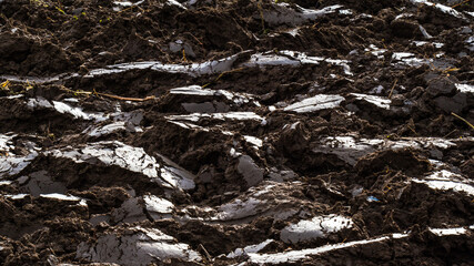 Brown glittering layers of plowed arable