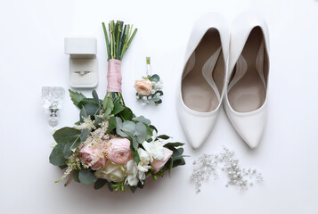 Composition with wedding high heel shoes on white background, top view