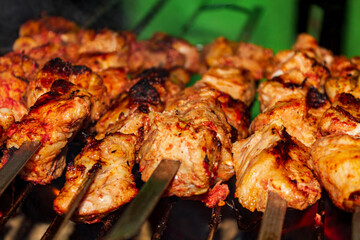 Russian shashlik with skewers on a round grill.