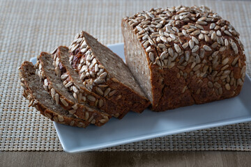 Sliced rye bread on the plate. Whole grain rye bread with seeds.