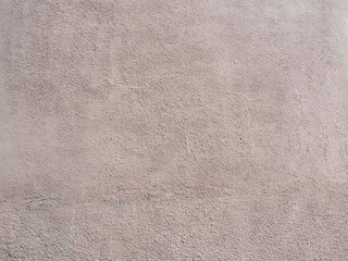 Fototapeta na wymiar Wall with beige pink grunge plaster. Texture not seamless. Full screen photo
