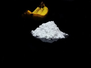 Welcome to Colombia - cocaine drug powder and bananas on black background