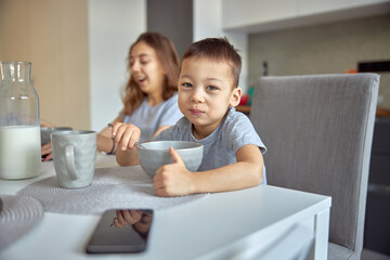 Cheerful happy family is having time at cozy home's dining room