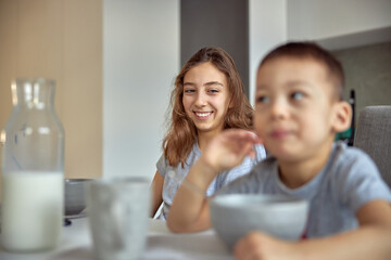 Cheerful happy family is having time at cozy home's dining room