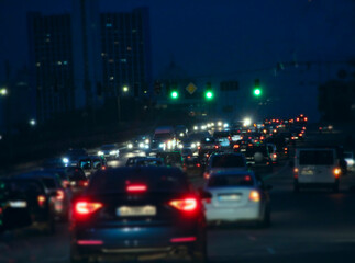 stream of cars in evening traffic jam. Automobiles with headlights