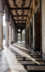 Columns of the temple of the Italian city in the rays of sunset