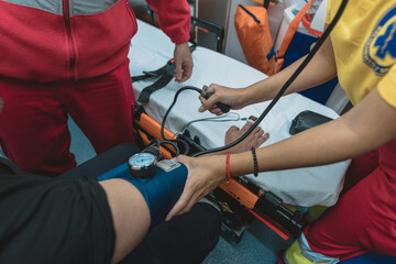 Fototapeta na wymiar a group of health workers help a patient do tests inside an ambulance