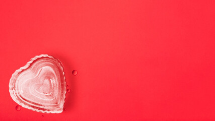 Heart shape ice cube on red background with copy space, happy valentine's day, mother's day, flat lay, top view