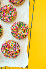 colorful sprinkle donuts on table