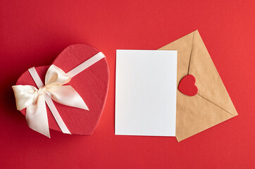 Valentines day card mockup with envelope and heart gift box on red paper background