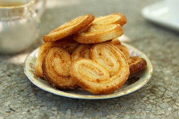 Cookies in a plate lie on the table