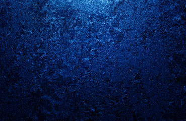 Dark blue frost texture on glass.