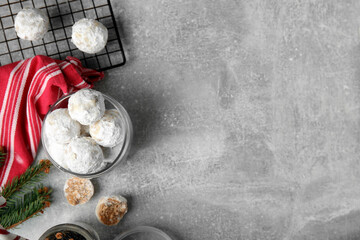 Obraz na płótnie Canvas Flat lay composition with Christmas snowball cookies on grey table, space for text