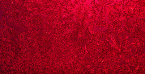 Dark red frost texture on glass surface.