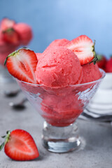 Delicious strawberry ice cream served on grey table