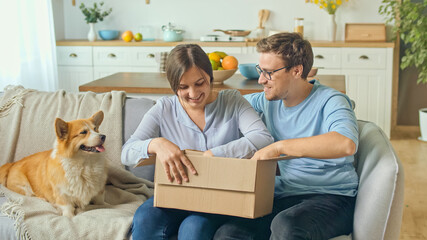 The Family Satisfied By a Quick Delivery. Unpacking of Order From Online Shops. Happy Family Opens Received Parcel in a Big Carton Box. Family Purchases Together.