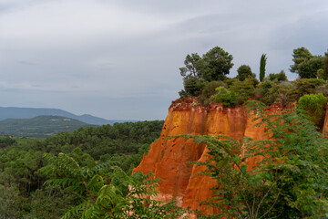 Colored ocher hill in Regional Park of Luberon, Roussillon landscape, Provence tourist attraction 
