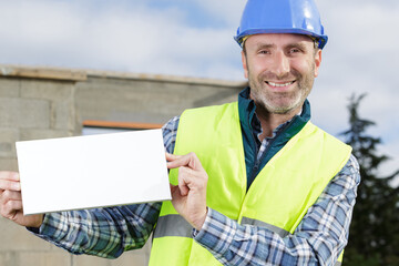 male construction worker holding blank advertising board