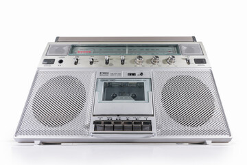 Obraz premium Old boom box AM FM radio, and cassette tape player portable stereo on white. 