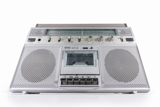 Old boom box AM FM radio, and cassette tape player portable stereo on white. 