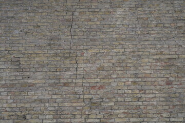 Old brick wall with defects and cracks