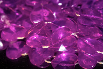 purple pink plastic heart beads in a pile