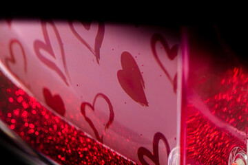 Red hearts on glitter photo block. Texture for Valentine's Day.