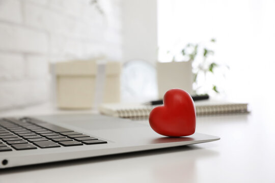 Red Heart On Laptop In Office, Space For Text. Valentine's Day Celebration