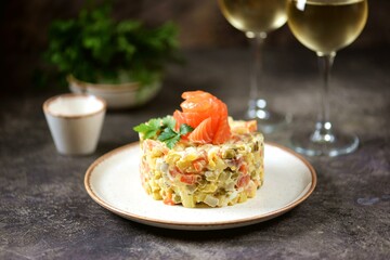Traditional Russian festive salad Olivier with lightly salted salmon.