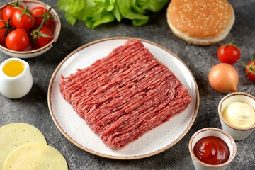 Fresh beef mince and ingredients ready to cook cheeseburgers.