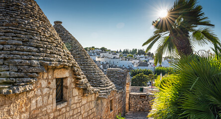 Sunshine on summer vacation in trulli town of Alberobello in Puglia, Italy