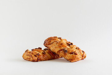 Two Danish maple pecan plaits pastry on a white background with copy space